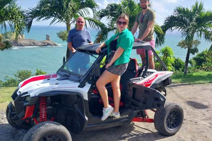 a man riding a motorcycle down a dirt road
