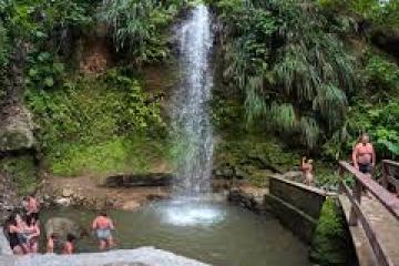 A group of people bathing at an exotic waterfall