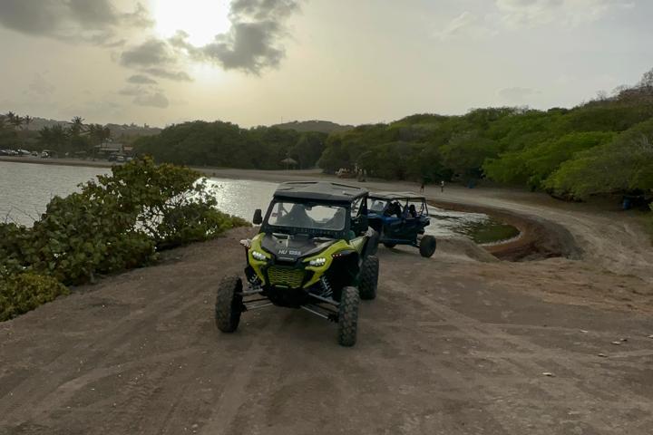 a motorcycle is parked on the side of a dirt road