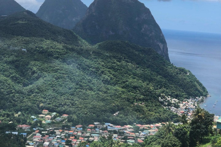 a view of a large body of water with Pitons in the background
