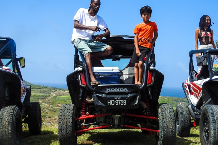 a group of people riding an off road vehicle buggy